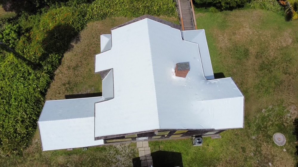 Same shake tile roof home fully sealed under a white RoofWrap membrane